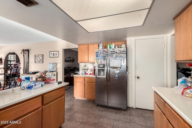 4957 W Onyx Ave, Glendale, AZ 85302 - kitchen featuring stainless steel refrigerator with ice dispenser, light countertops, and dark tile patterned floors
