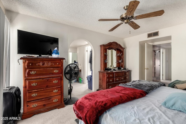 4957 W Onyx Ave, Glendale, AZ 85302 - bedroom with light carpet, arched walkways, a textured ceiling, and a ceiling fan