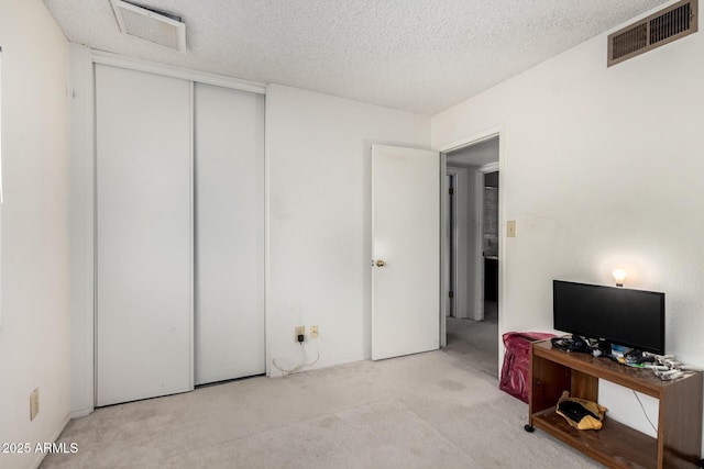 4957 W Onyx Ave, Glendale, AZ 85302 - carpeted bedroom with a textured ceiling and a closet