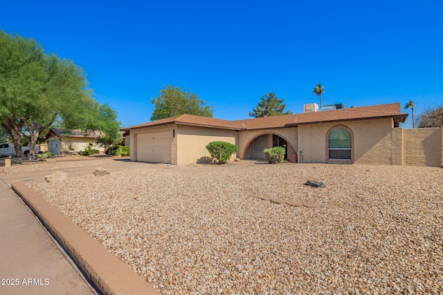 4957 W Onyx Ave, Glendale, AZ 85302 - ranch-style home featuring stucco siding, an attached garage, and driveway
