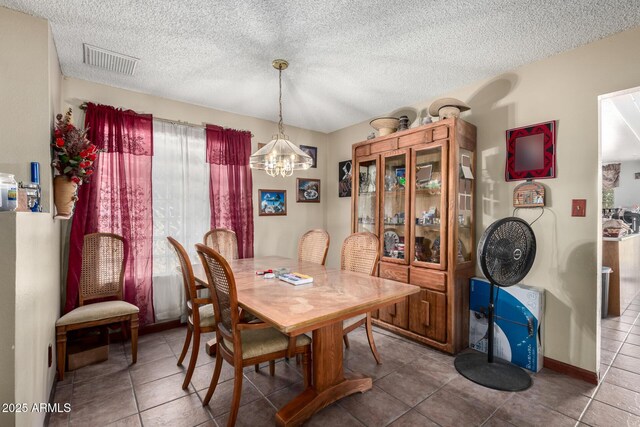 4957 W Onyx Ave, Glendale, AZ 85302 - tiled dining space featuring a chandelier and a textured ceiling