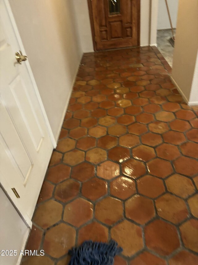 hallway featuring baseboards