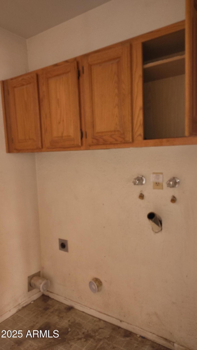 laundry area featuring gas dryer hookup, cabinet space, washer hookup, and electric dryer hookup