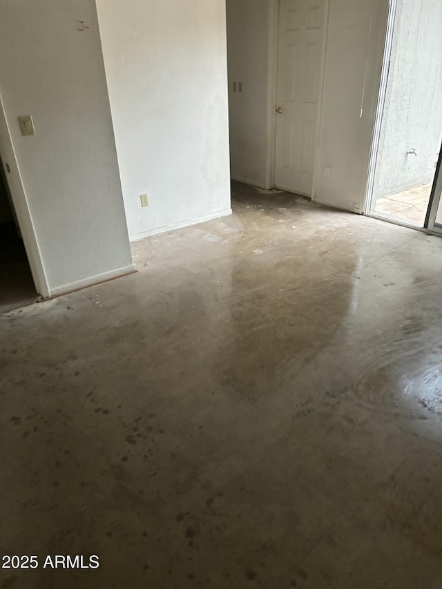 unfurnished room featuring concrete floors