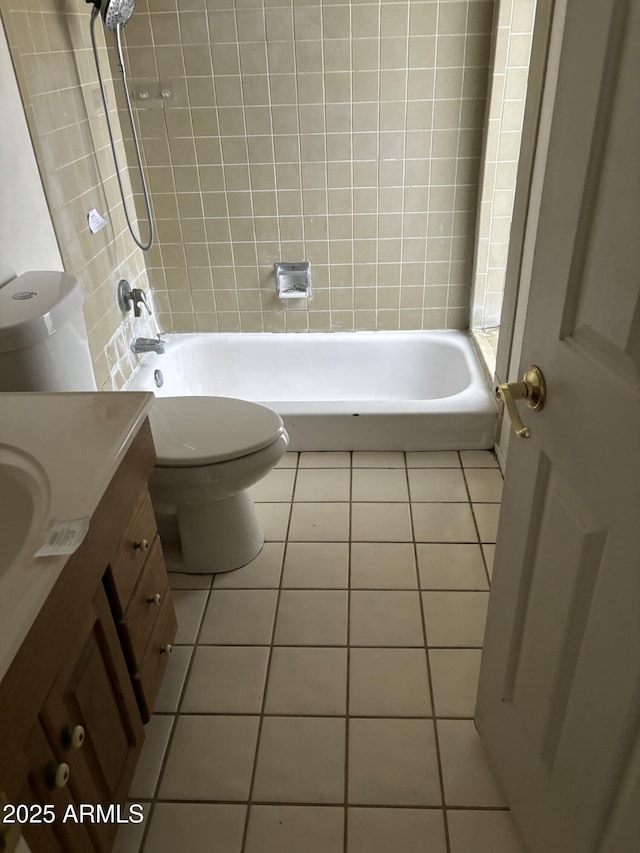 bathroom with toilet, vanity, shower / washtub combination, and tile patterned floors