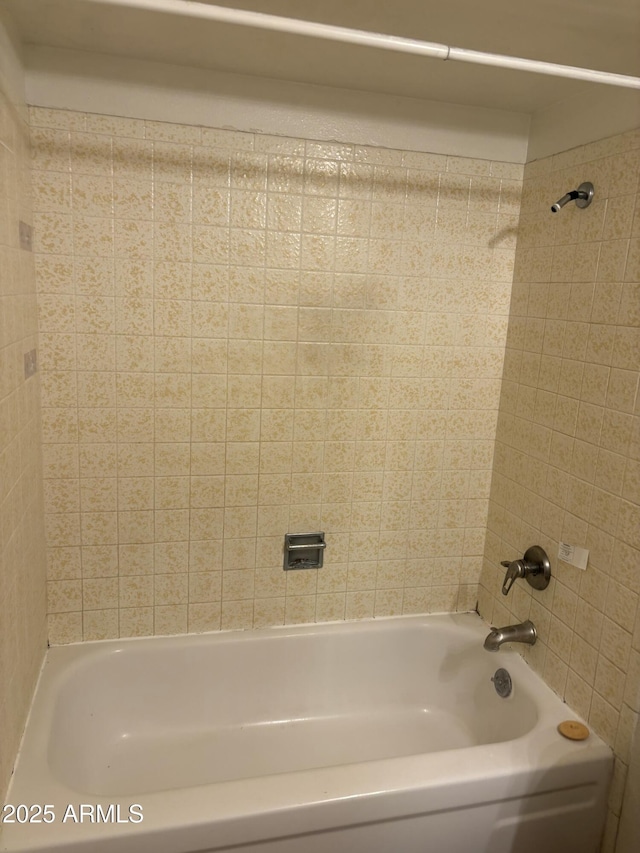 bathroom with bathing tub / shower combination