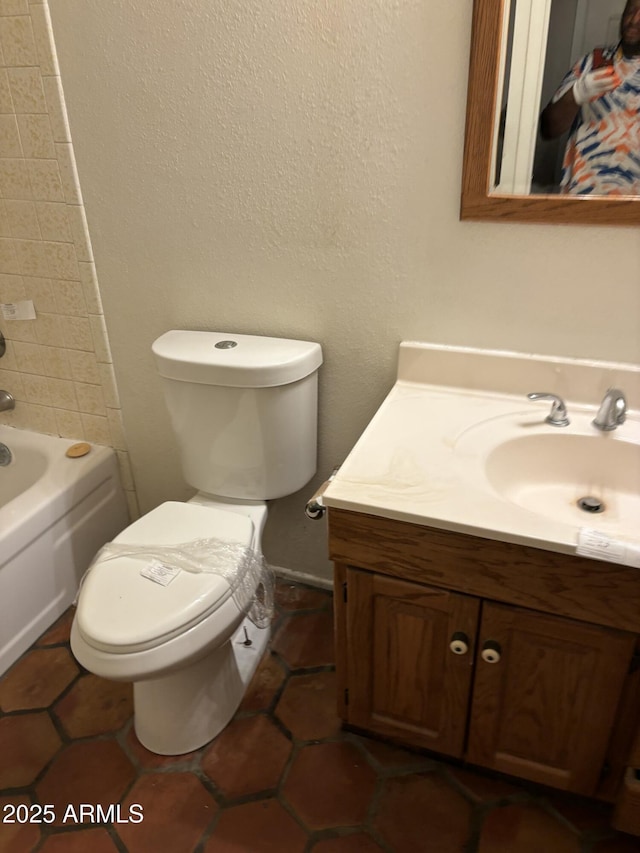 full bathroom with tile patterned flooring, tub / shower combination, vanity, and toilet