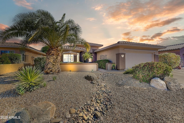 16857 W Villagio Dr, Surprise, AZ 85387 - view of front of property featuring a garage, stucco siding, and a tile roof