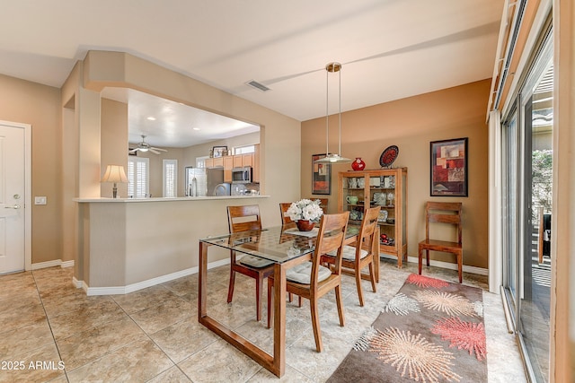16857 W Villagio Dr, Surprise, AZ 85387 - dining space with baseboards, ceiling fan, and light tile patterned flooring