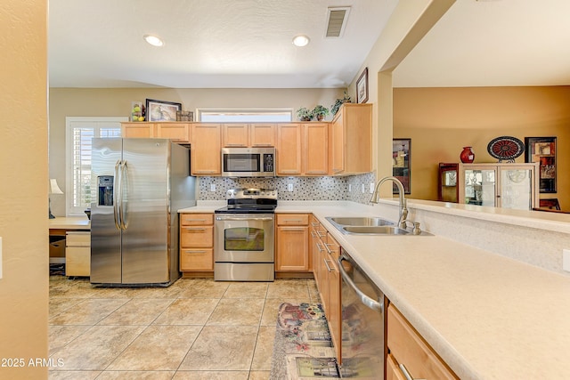 16857 W Villagio Dr, Surprise, AZ 85387 - kitchen featuring stainless steel appliances, a sink, light brown cabinetry, and recessed lighting