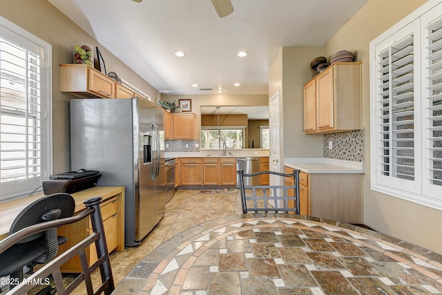 16857 W Villagio Dr, Surprise, AZ 85387 - kitchen featuring light countertops, light brown cabinets, decorative backsplash, appliances with stainless steel finishes, and recessed lighting