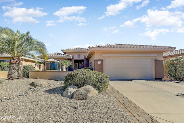 16857 W Villagio Dr, Surprise, AZ 85387 - view of front of house featuring stucco siding, a tile roof, driveway, and an attached garage