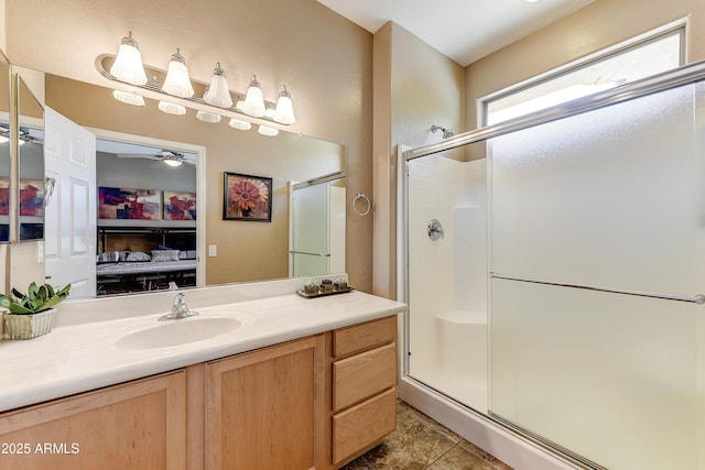 16857 W Villagio Dr, Surprise, AZ 85387 - bathroom featuring a stall shower, vanity, ceiling fan, and ensuite bathroom