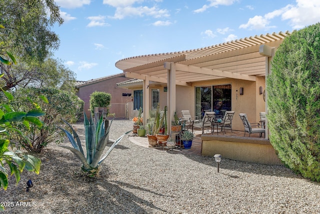 16857 W Villagio Dr, Surprise, AZ 85387 - back of house with stucco siding, a pergola, a patio area, fence, and a tiled roof