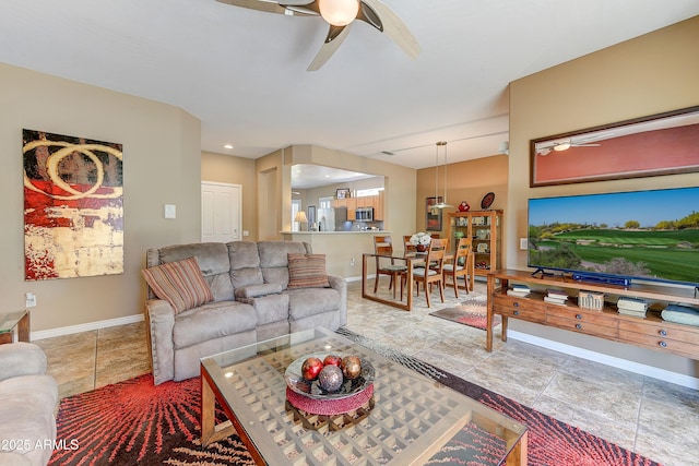 16857 W Villagio Dr, Surprise, AZ 85387 - living room with a ceiling fan, baseboards, and arched walkways