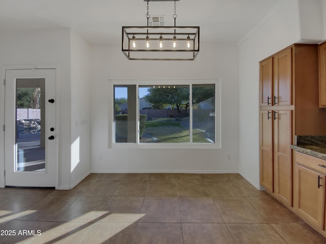 unfurnished dining area with light tile patterned floors