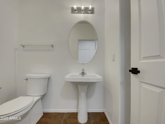 bathroom with tile patterned flooring, toilet, and sink