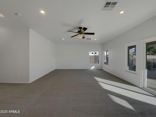 carpeted spare room featuring ceiling fan