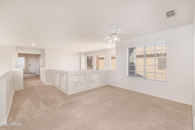 empty room with light carpet and ceiling fan