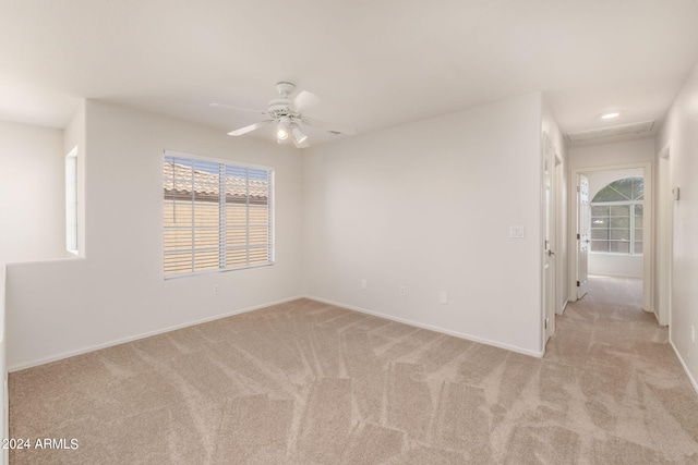 carpeted empty room featuring ceiling fan