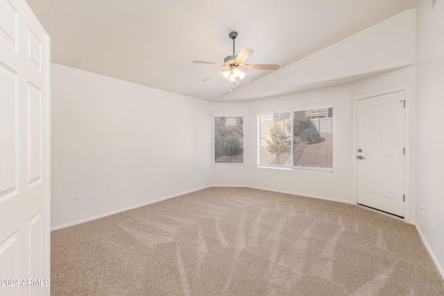 carpeted empty room with ceiling fan and lofted ceiling