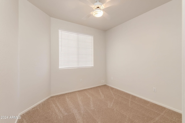 empty room with ceiling fan and light colored carpet