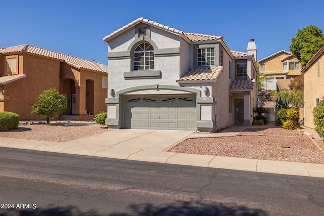 mediterranean / spanish home featuring a garage