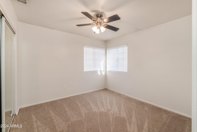 unfurnished room with carpet flooring and ceiling fan