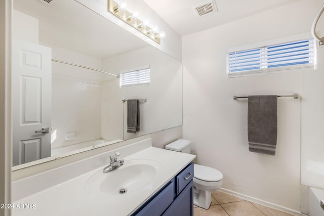 full bathroom featuring a healthy amount of sunlight, vanity, toilet, and tile patterned floors