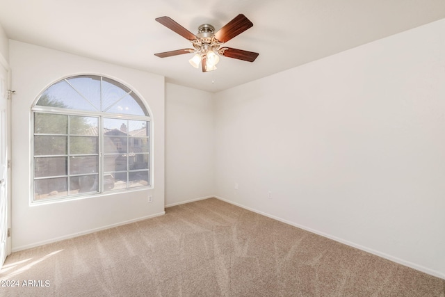 empty room with ceiling fan and light colored carpet