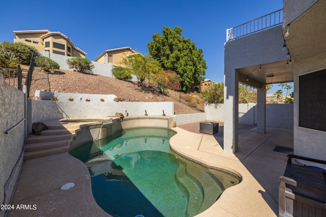 view of swimming pool featuring an in ground hot tub and a patio