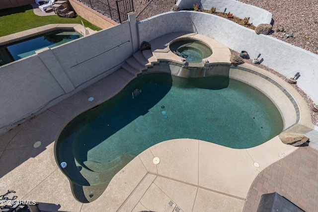 view of pool with an in ground hot tub