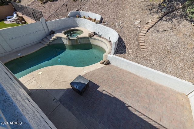 exterior details featuring a swimming pool with hot tub