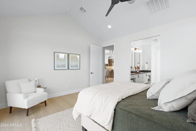 bedroom featuring ensuite bathroom, light hardwood / wood-style flooring, ceiling fan, and high vaulted ceiling