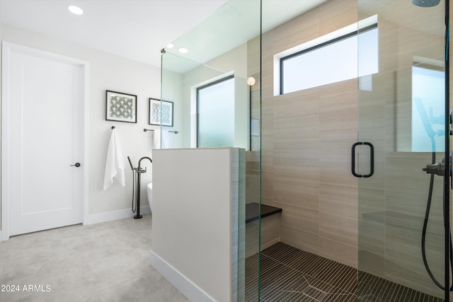 bathroom with a shower with door