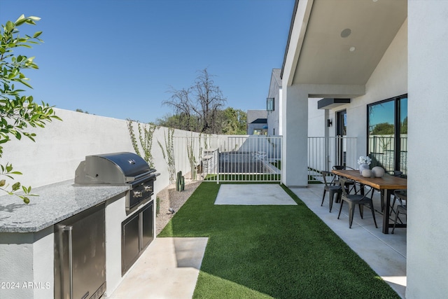 exterior space featuring a patio area and exterior kitchen