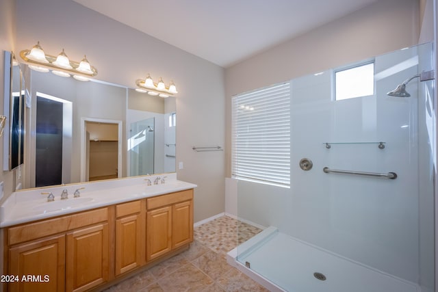 bathroom with a shower, tile patterned flooring, and vanity