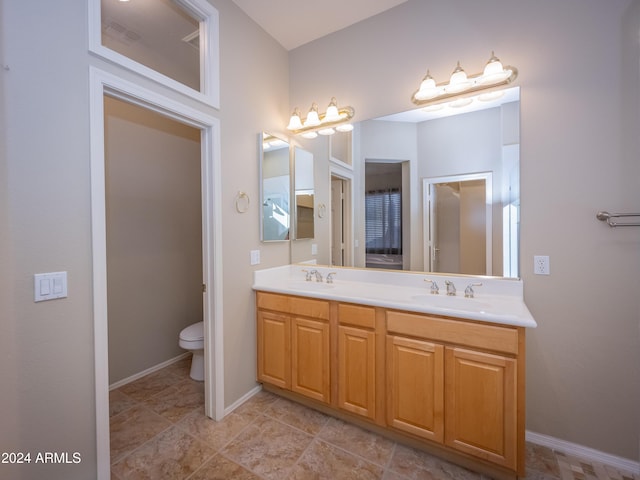 bathroom with tile patterned floors, vanity, and toilet