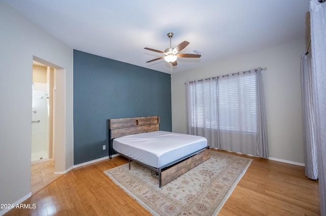 bedroom with ceiling fan and light wood-type flooring