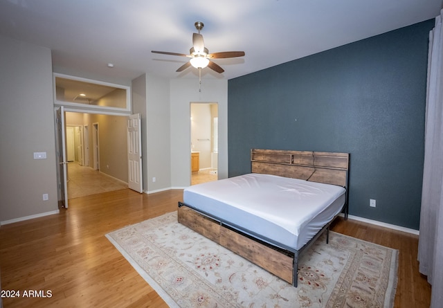 bedroom with hardwood / wood-style flooring, ceiling fan, and ensuite bathroom