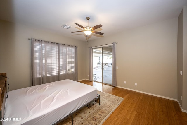 bedroom featuring wood-type flooring, access to outside, and ceiling fan