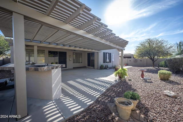 view of patio / terrace with a pergola and exterior kitchen