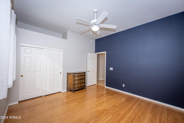 unfurnished bedroom featuring ceiling fan, a closet, and light hardwood / wood-style flooring