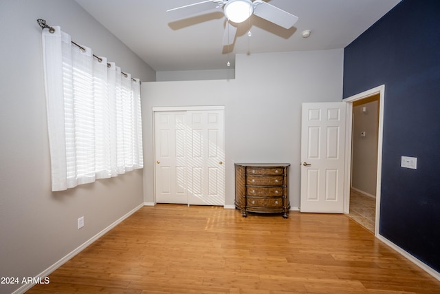 unfurnished bedroom featuring light hardwood / wood-style floors, a closet, and ceiling fan