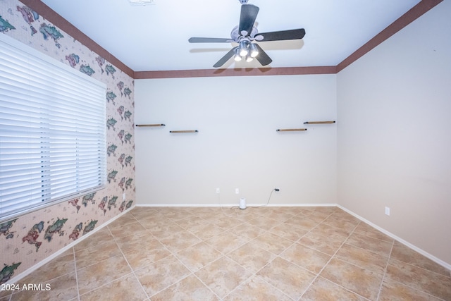 unfurnished room featuring ceiling fan and crown molding