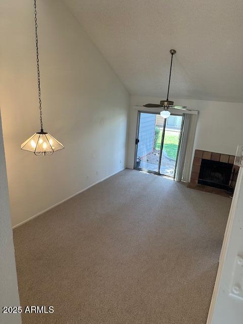 14002 N 49th Ave Unit 1021, Glendale, AZ 85306 - unfurnished living room with carpet flooring, vaulted ceiling, a ceiling fan, and a fireplace
