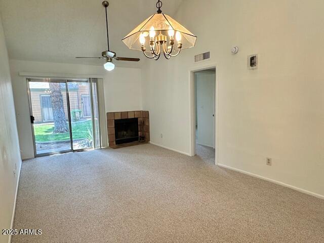 14002 N 49th Ave Unit 1021, Glendale, AZ 85306 - unfurnished living room with light carpet, a chandelier, ceiling fan, and a tiled fireplace