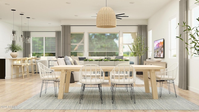 dining room featuring breakfast area and light wood-type flooring