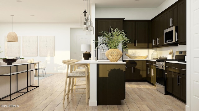 kitchen with a center island, a kitchen breakfast bar, light wood-type flooring, decorative light fixtures, and stainless steel appliances