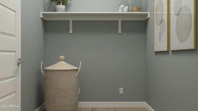 clothes washing area featuring light wood-type flooring